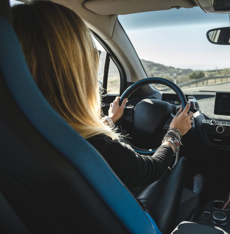 woman driving electric vehicle